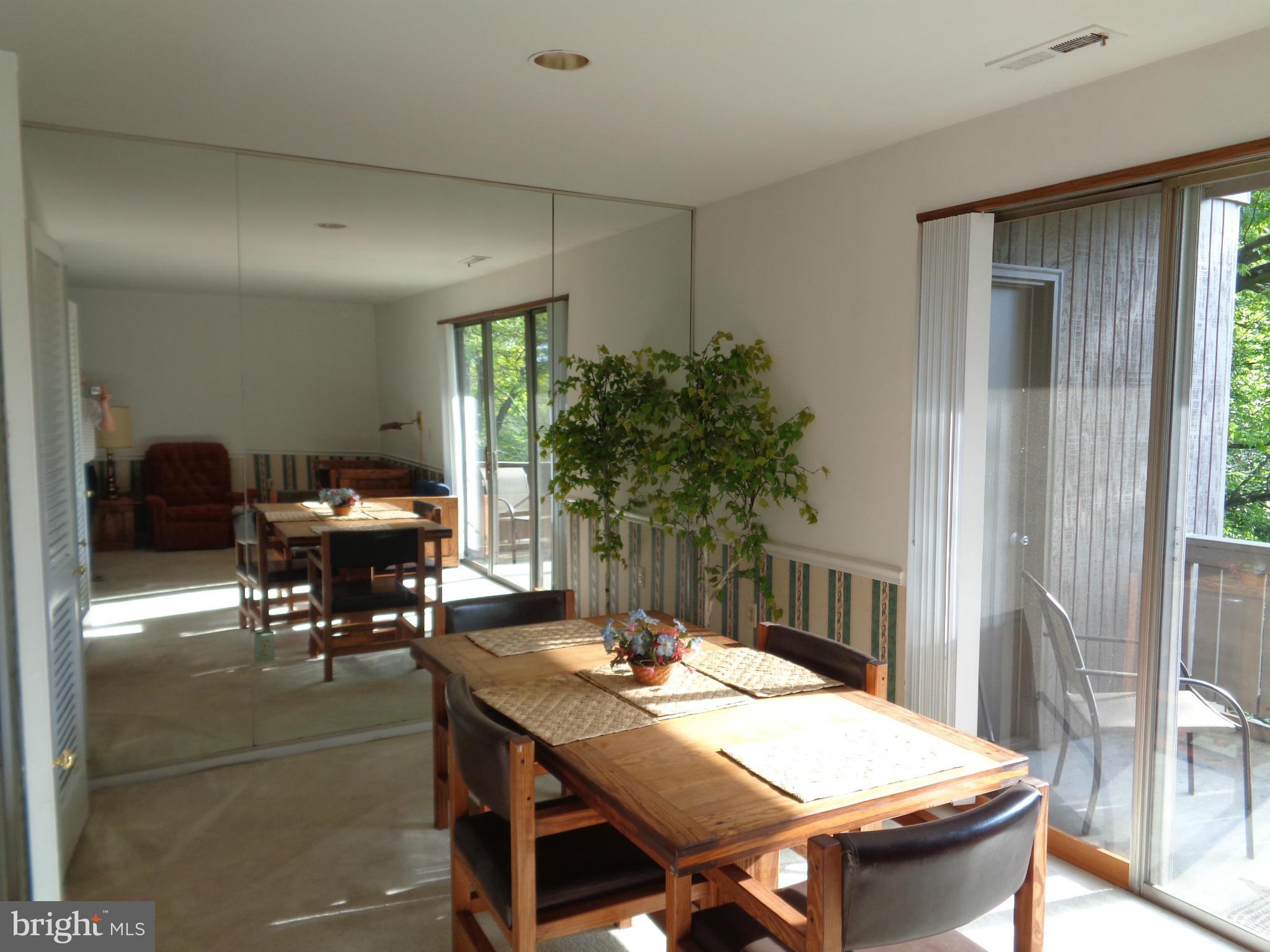 114 Cross Keys Road, Unit R114D Baltimore, MD 21210 - Photo 7 of 22 a view of a dining room with furniture and window