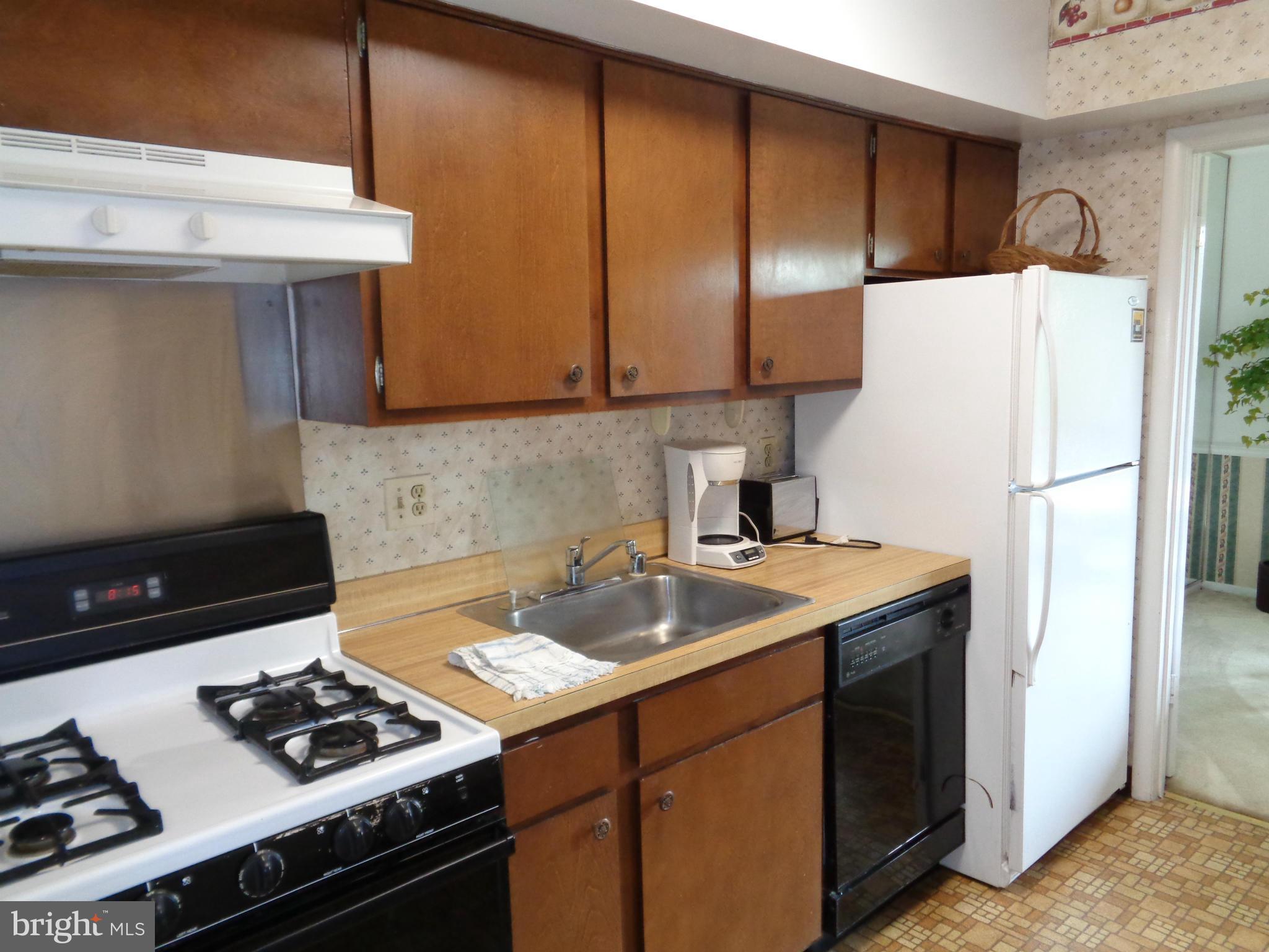 114 Cross Keys Road, Unit R114D Baltimore, MD 21210 - Photo 8 of 22 a kitchen with a sink a stove and refrigerator