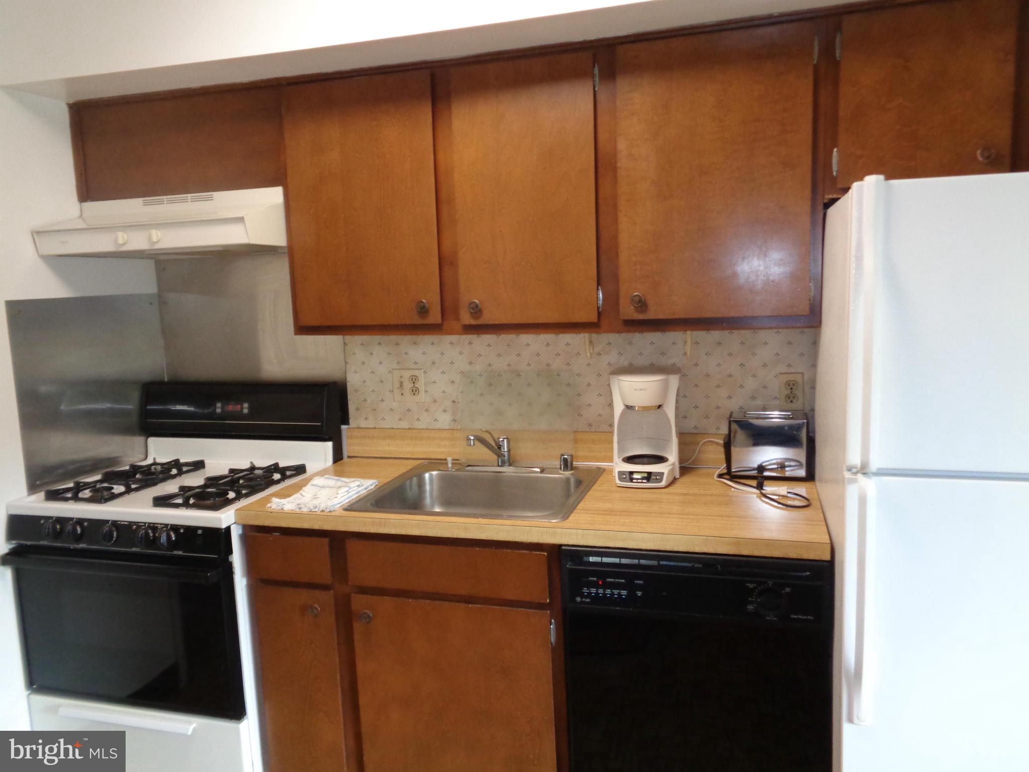 114 Cross Keys Road, Unit R114D Baltimore, MD 21210 - Photo 10 of 22 a kitchen with a sink a stove and a refrigerator