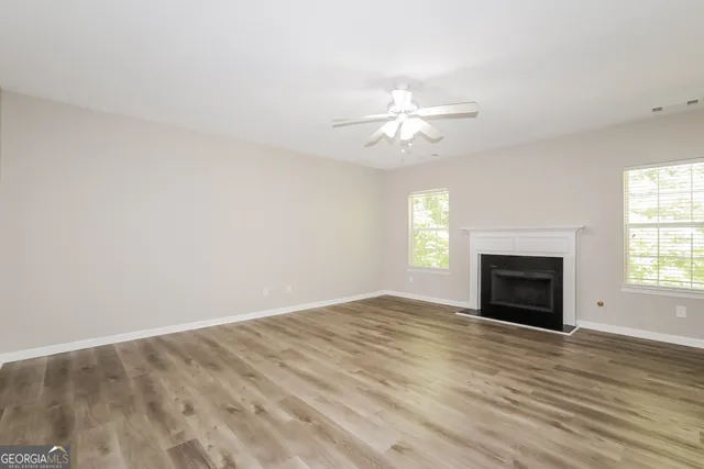 a view of empty room with a fireplace
