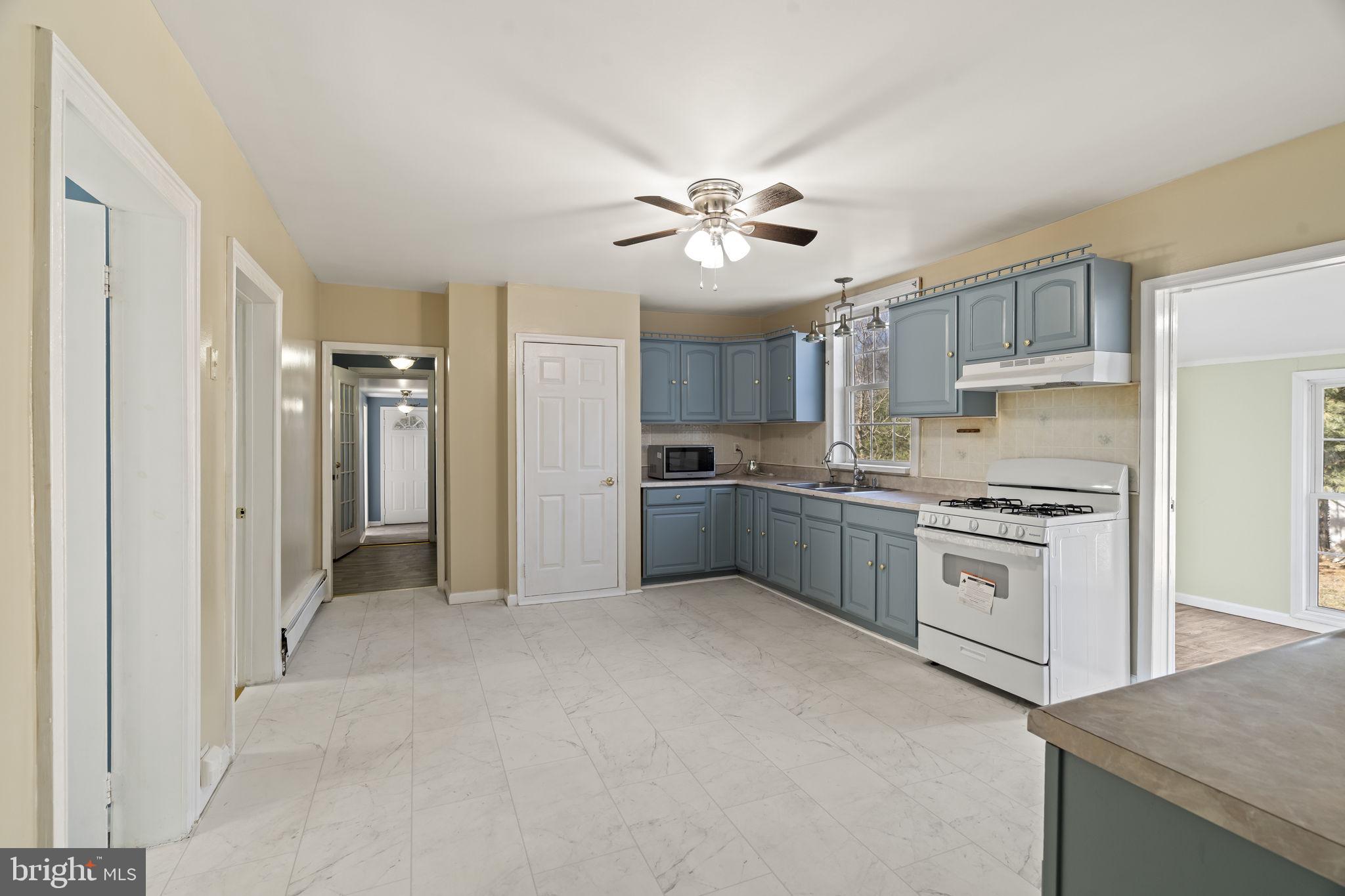 2810 Panther Road Vineland, NJ 08361 - Photo 4 of 20 a kitchen with stainless steel appliances granite countertop a stove a sink and a refrigerator