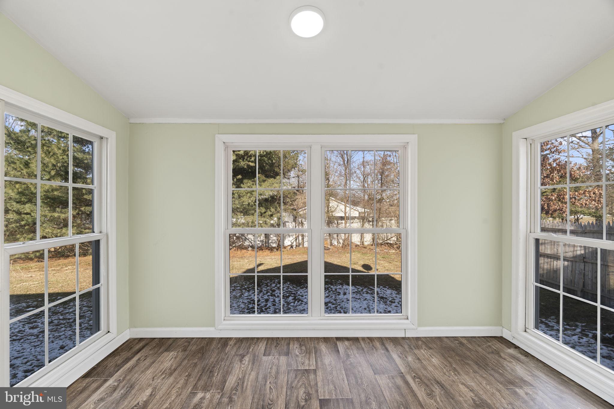 2810 Panther Road Vineland, NJ 08361 - Photo 6 of 20 an empty room with wooden floor and windows