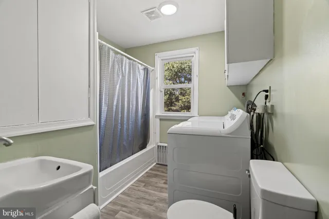 a bathroom with a sink a toilet and bathtub