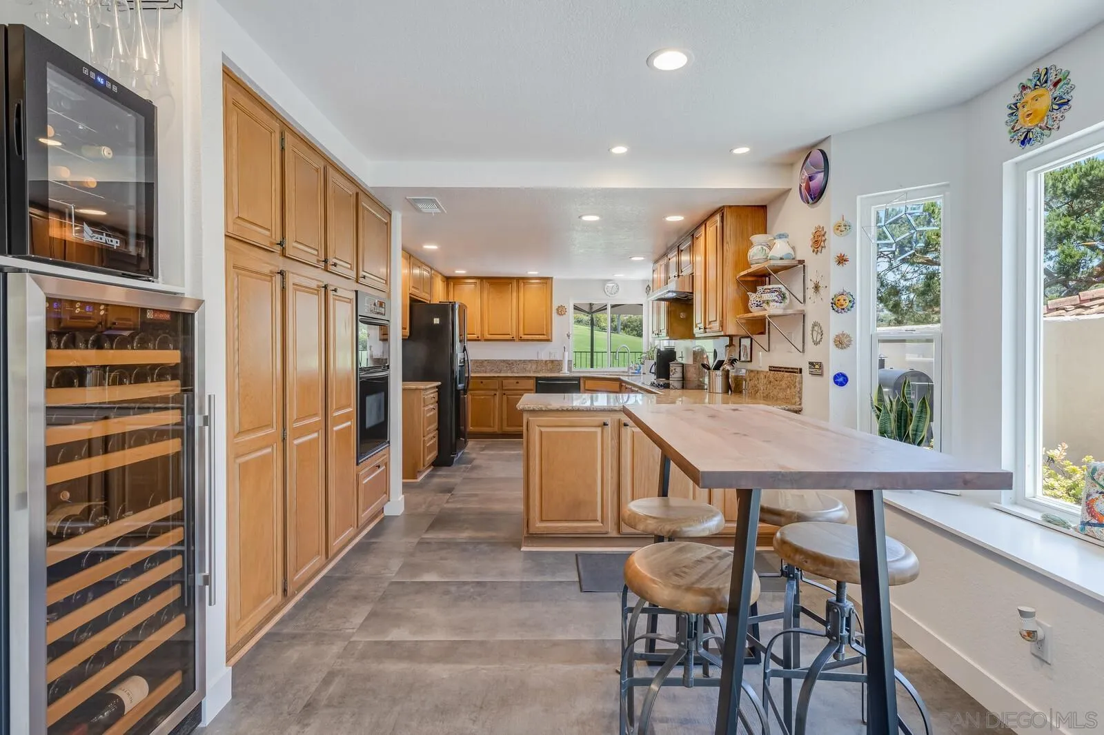 14921 Tercer Verde Del Mar, CA 92014 - Photo 11 of 37 a kitchen with a table chairs refrigerator and a window