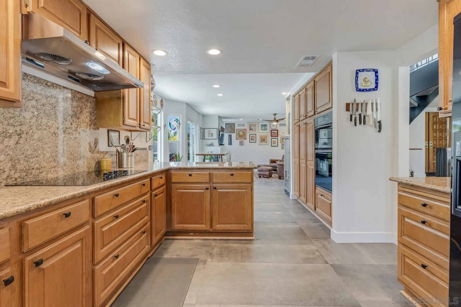 14921 Tercer Verde Del Mar, CA 92014 - Photo 13 of 37 a large kitchen with stainless steel appliances granite countertop a refrigerator and a sink