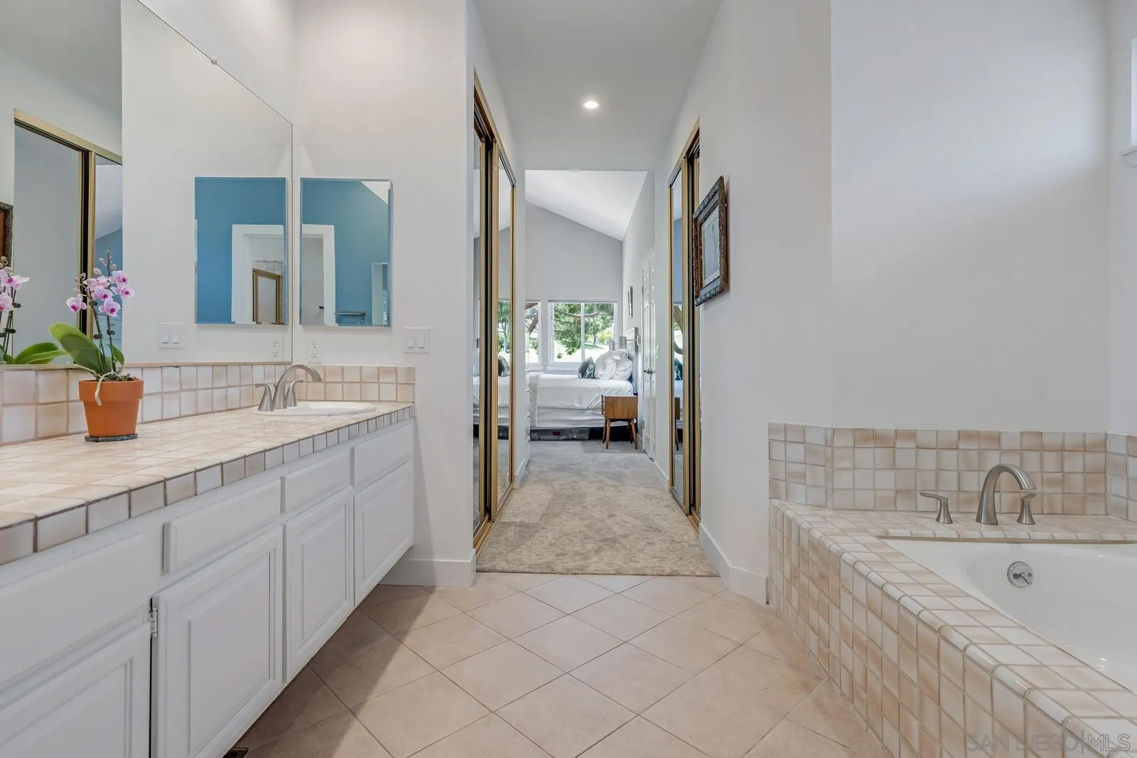 14921 Tercer Verde Del Mar, CA 92014 - Photo 20 of 37 a spacious bathroom with a double vanity sink a mirror and a bathtub