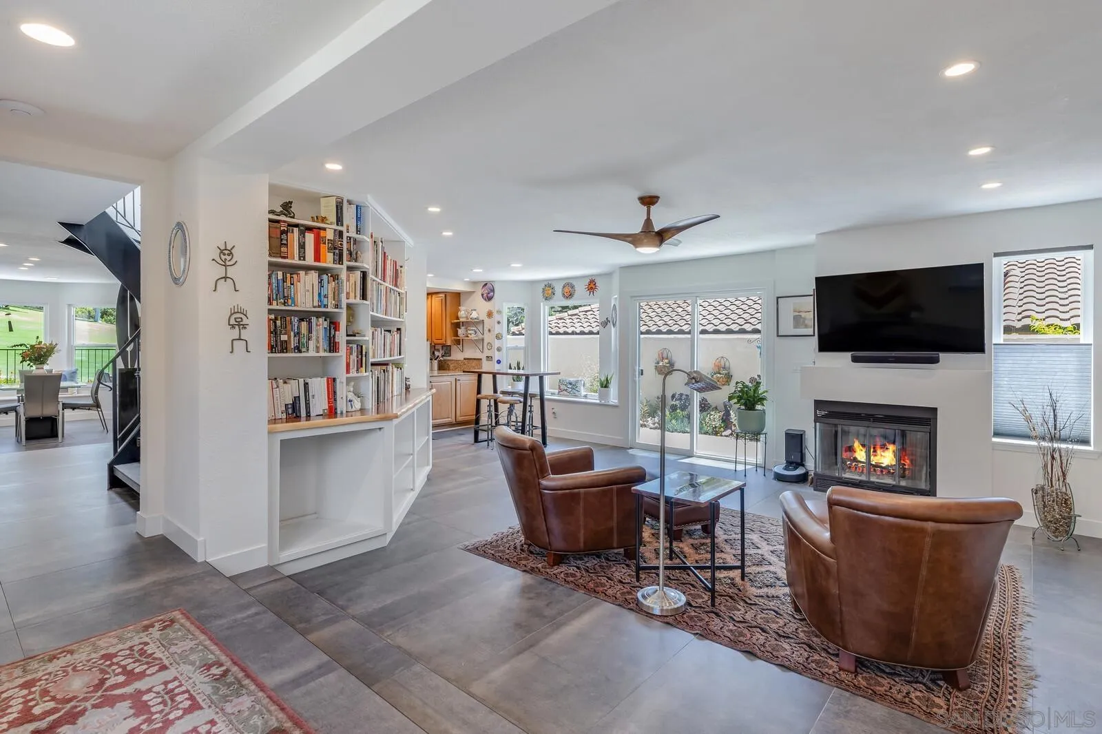 14921 Tercer Verde Del Mar, CA 92014 - Photo 9 of 37 a living room with furniture a fireplace and a flat screen tv