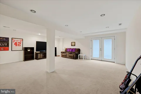 a bedroom with a bed window and mirror