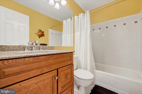 a bedroom with a bed a couch and dresser