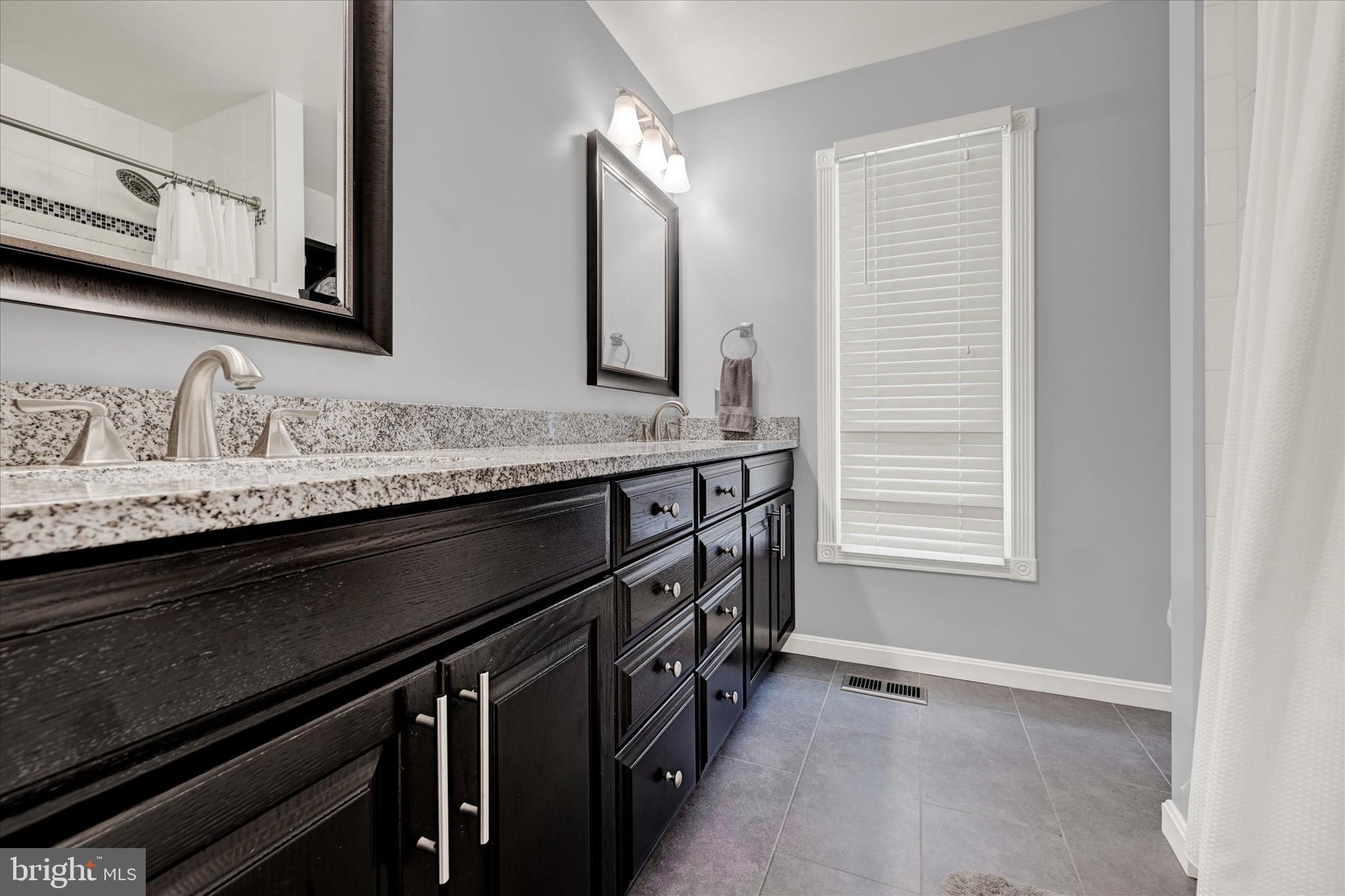 9006 Naygall Road Baltimore, MD 21234 - Photo 26 of 34 a bathroom with a sink double vanity and a mirror