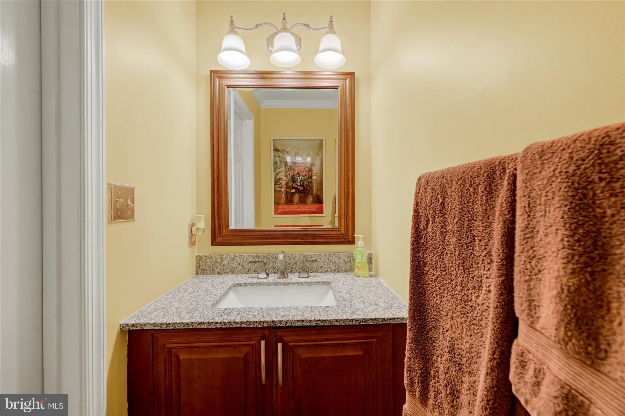 9006 Naygall Road Baltimore, MD 21234 - Photo 7 of 34 a bathroom with a granite countertop sink and a mirror