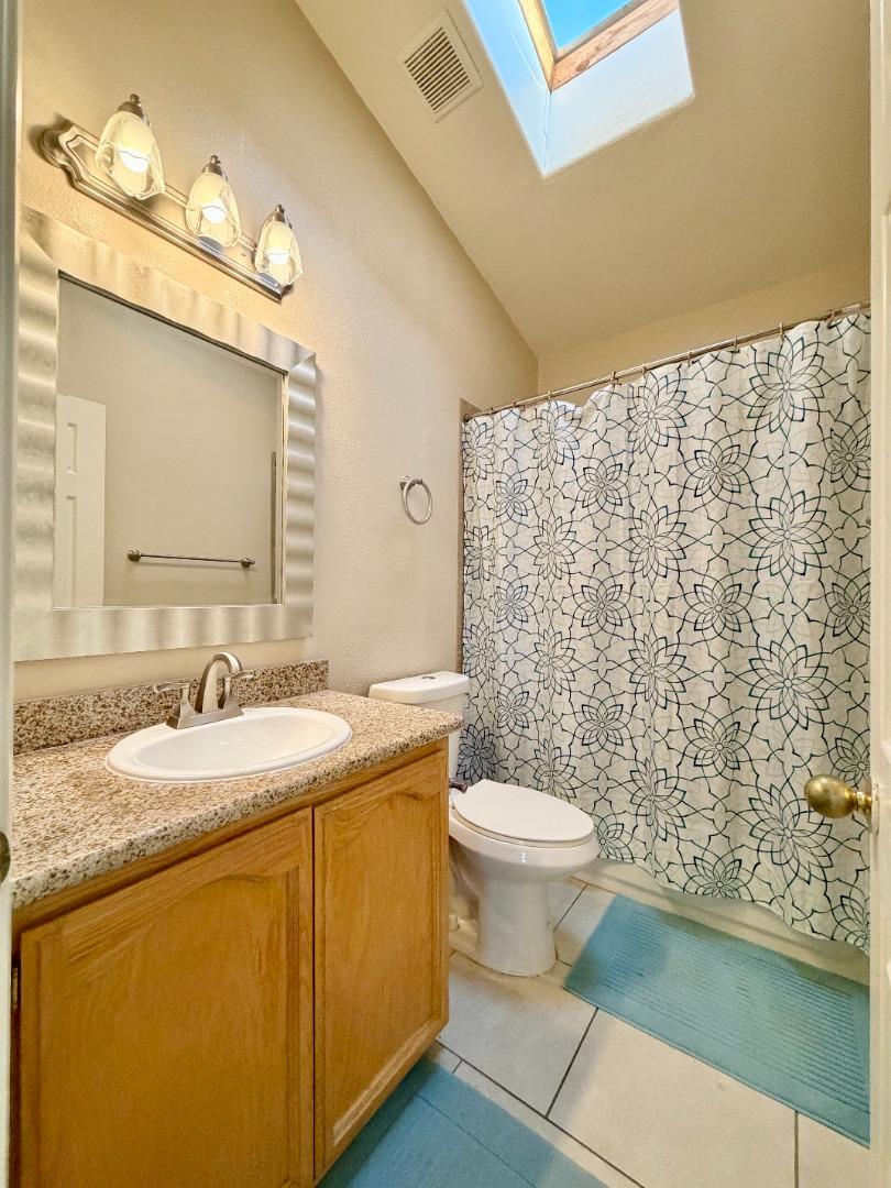 120 Dixon Landing Road, Unit 147 Milpitas, CA 95035 - Photo 12 of 21 a bathroom with a granite countertop sink mirror vanity and toilet