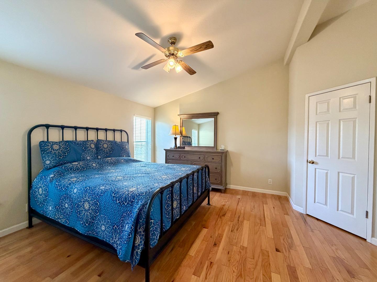 120 Dixon Landing Road, Unit 147 Milpitas, CA 95035 - Photo 13 of 21 a bedroom with a bed and wooden floor