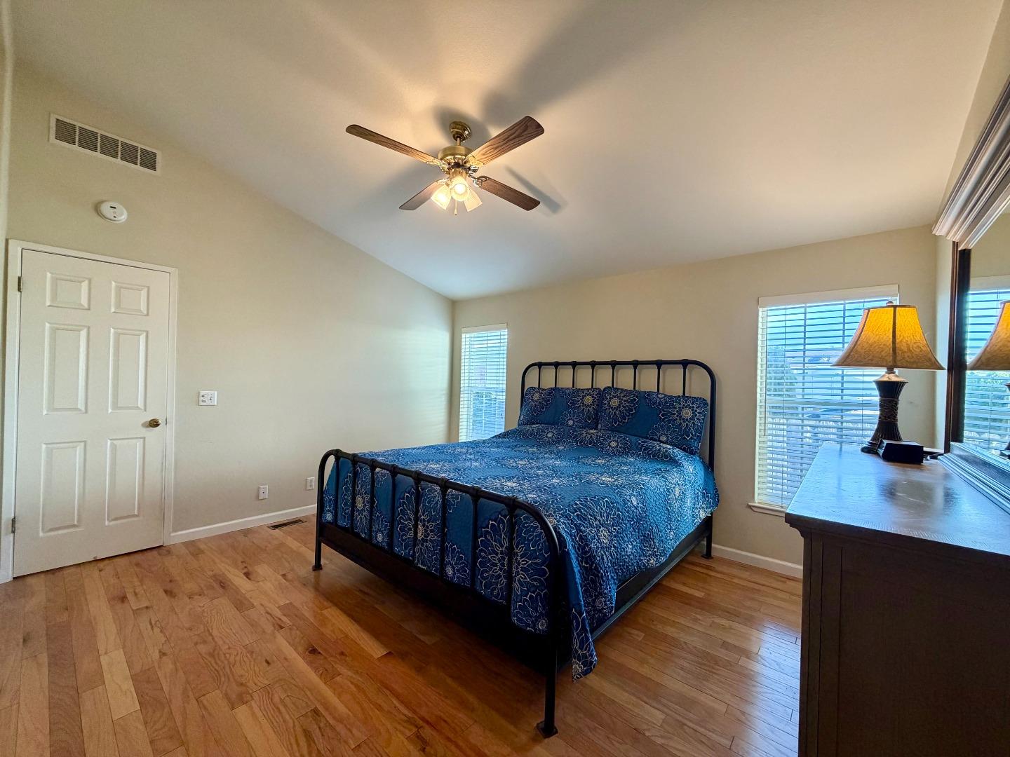 120 Dixon Landing Road, Unit 147 Milpitas, CA 95035 - Photo 14 of 21 a bedroom with a bed and wooden floor