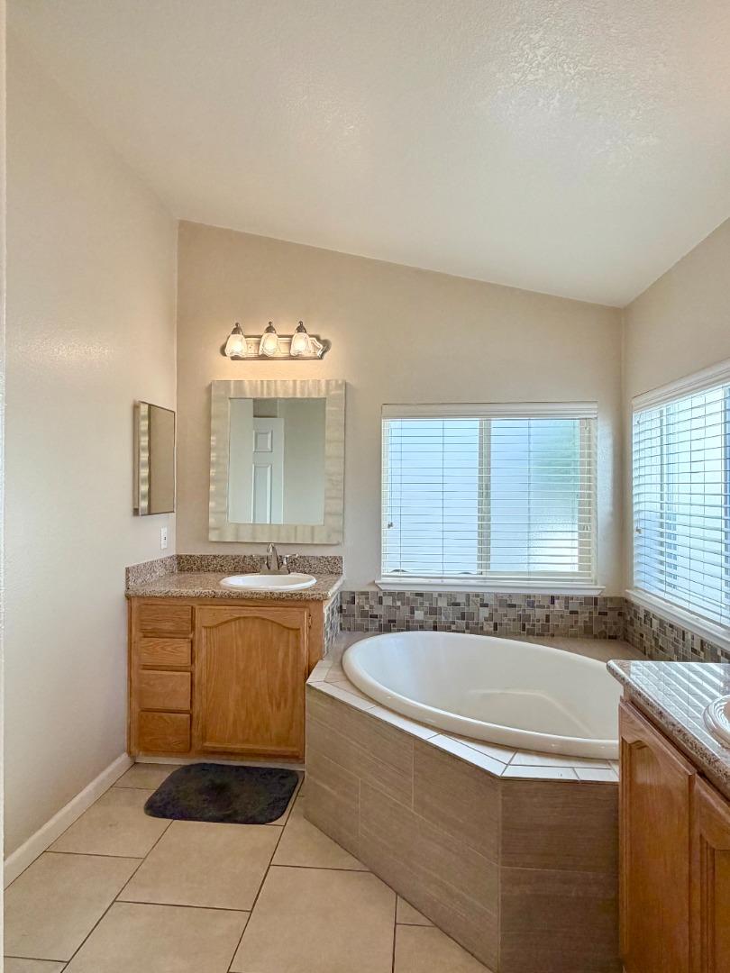 120 Dixon Landing Road, Unit 147 Milpitas, CA 95035 - Photo 16 of 21 a bathroom with a granite countertop sink and mirror