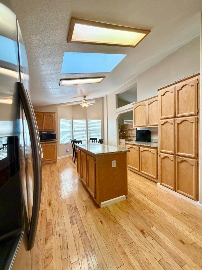 120 Dixon Landing Road, Unit 147 Milpitas, CA 95035 - Photo 6 of 21 a large kitchen with stainless steel appliances granite countertop a lot of counter space and wooden floors
