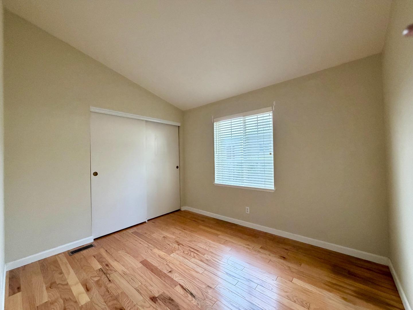 120 Dixon Landing Road, Unit 147 Milpitas, CA 95035 - Photo 10 of 21 a view of an empty room with wooden floor and a window