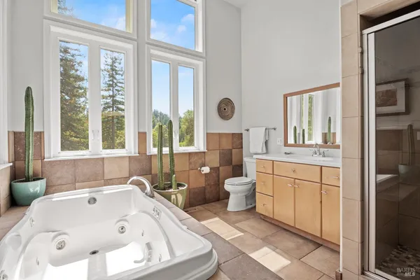 a bathroom with a tub sink and a large window