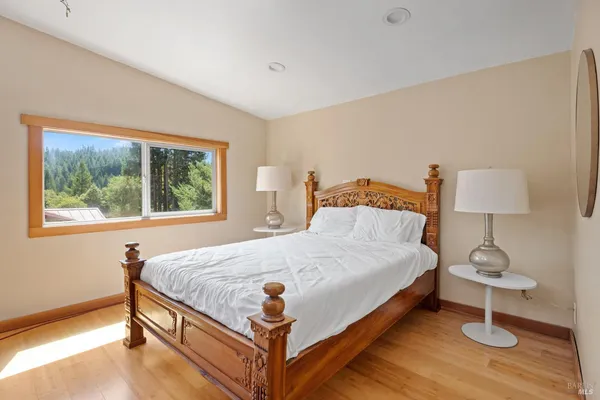 a bed sitting in a bedroom next to a window
