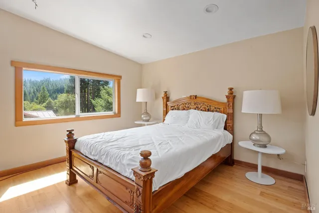 a bed sitting in a bedroom next to a window