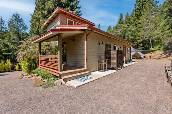 a view of house with backyard and trees