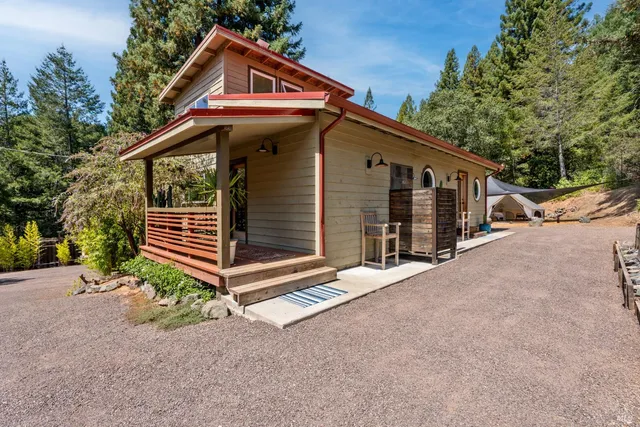 a view of house with backyard and trees
