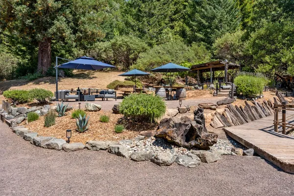 an outdoor space with patio and white umbrellas