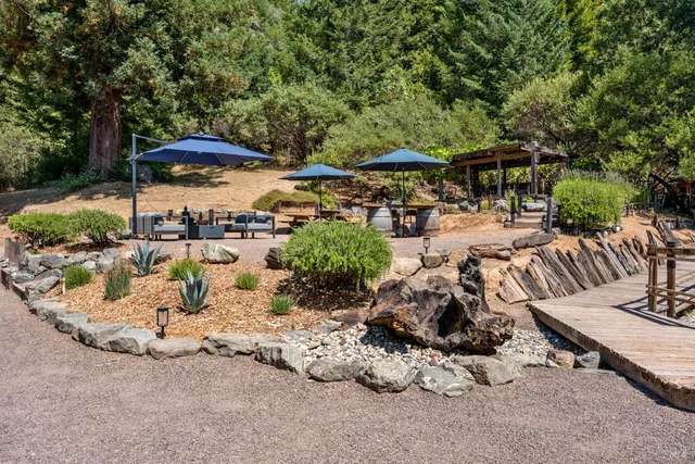 an outdoor space with patio and white umbrellas