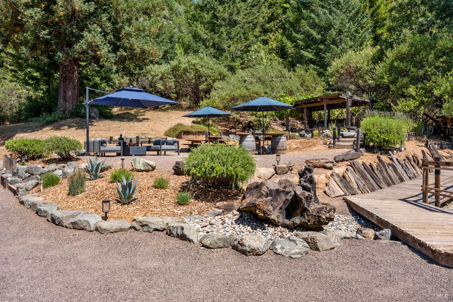 4901 Little Mill Creek Road Philo, CA 95466 - Photo 22 of 37 an outdoor space with patio and white umbrellas