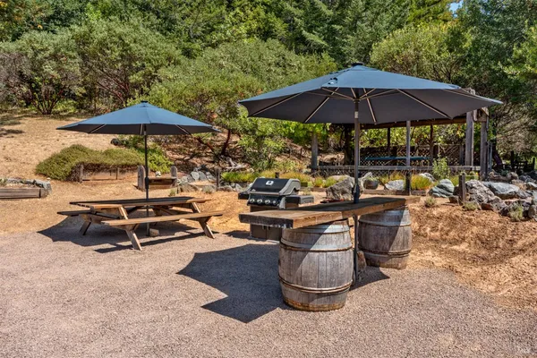 a view of a backyard with sitting area and a umbrella