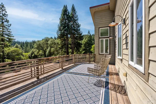 a backyard of a house with barbeque oven table and chairs