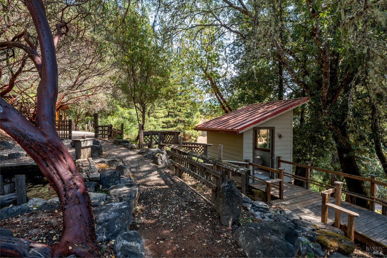 4901 Little Mill Creek Road Philo, CA 95466 - Photo 27 of 37 a backyard of a house with barbeque oven table and chairs