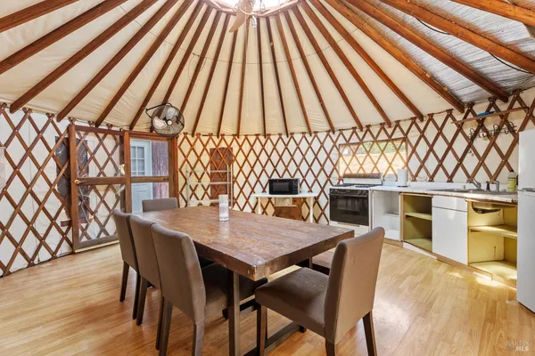 a yellow house with trees in front of it