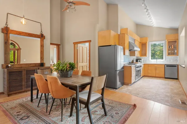 a view of a dining room with furniture and a refrigerator