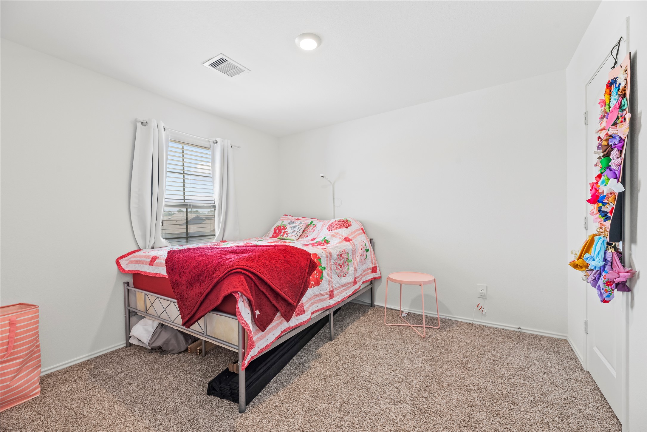 22603 Aspen Tarn Trail Spring, TX 77373 - Photo 14 of 21 a bed sitting in a bedroom next to a window and a larger window