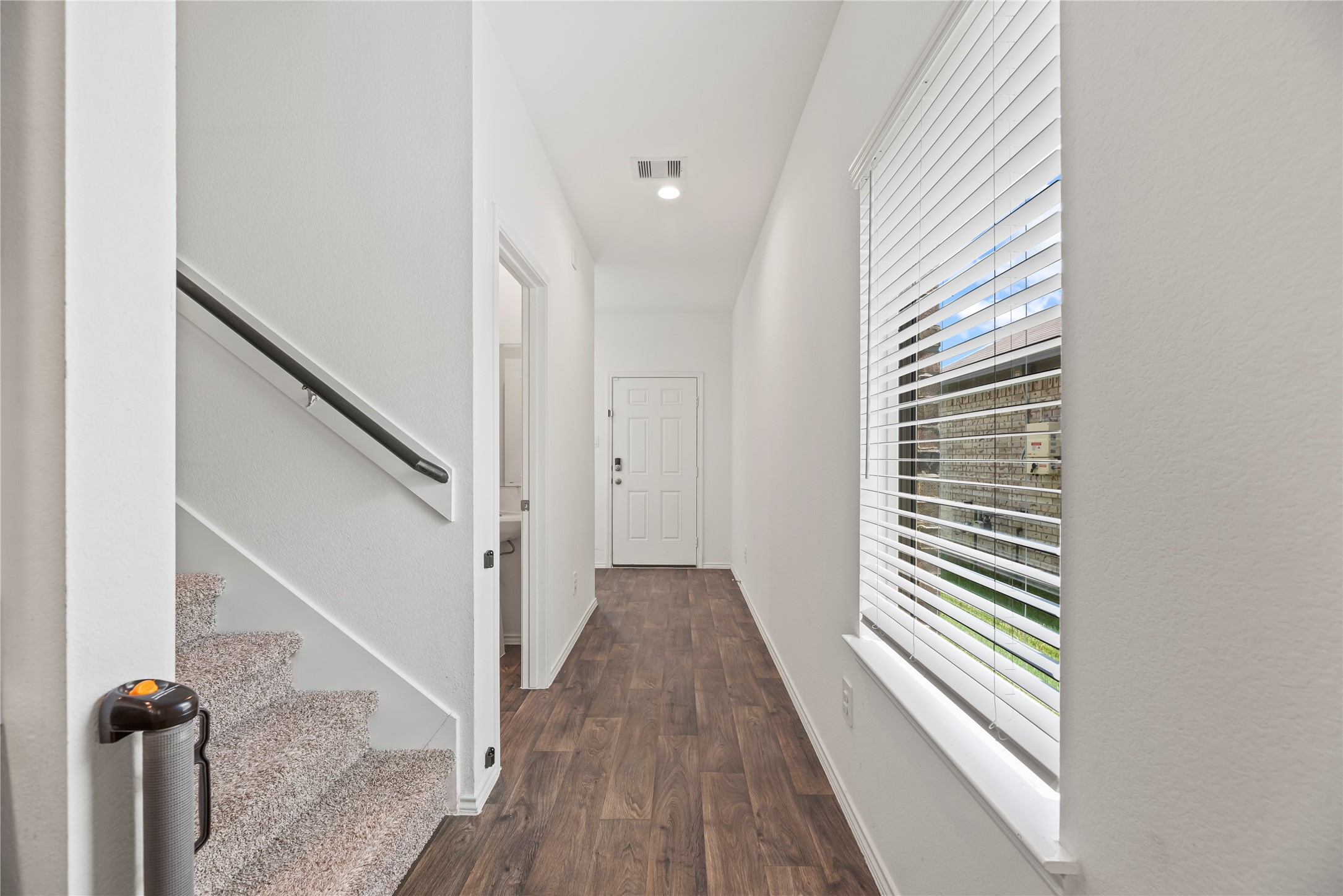 22603 Aspen Tarn Trail Spring, TX 77373 - Photo 15 of 21 a view of a hallway with wooden floor and staircase