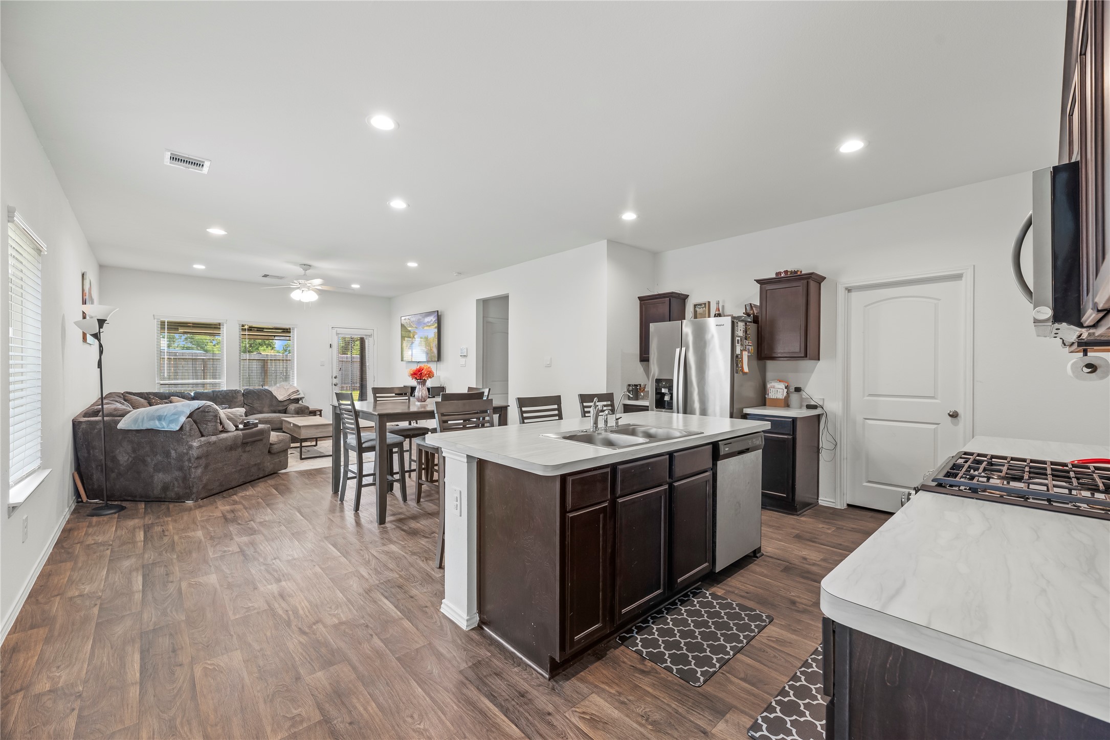 22603 Aspen Tarn Trail Spring, TX 77373 - Photo 7 of 21 a kitchen with a stove a refrigerator and a dining table with wooden floor