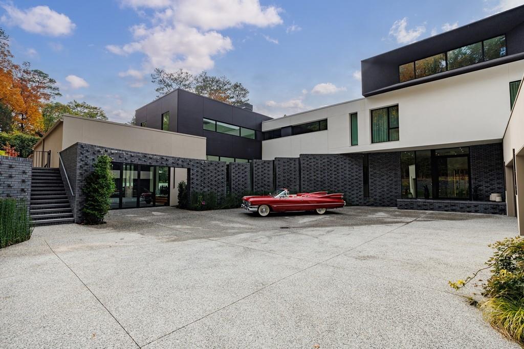 380 West Wesley Road Northwest Atlanta, GA 30305 - Photo 12 of 104 a view of a house with a yard and garage