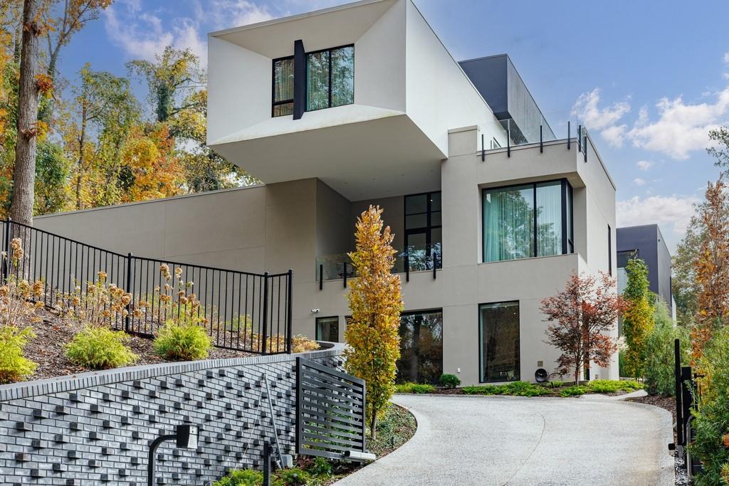 380 West Wesley Road Northwest Atlanta, GA 30305 - Photo 2 of 104 a front view of a house with a garden