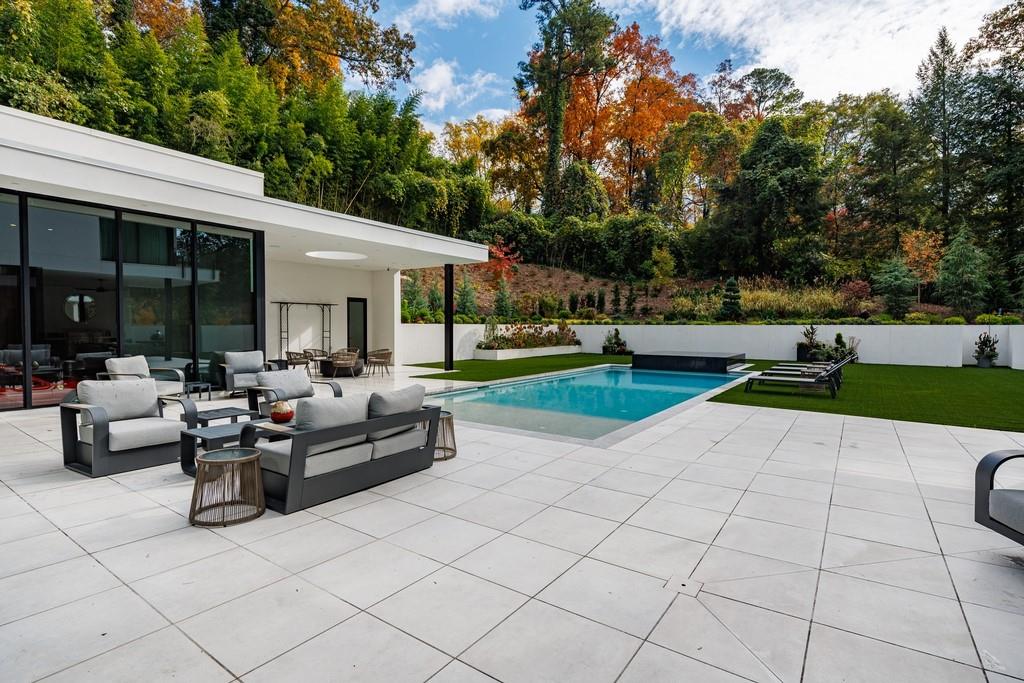380 West Wesley Road Northwest Atlanta, GA 30305 - Photo 4 of 104 a view of a patio with couches and a table and chairs with garden view