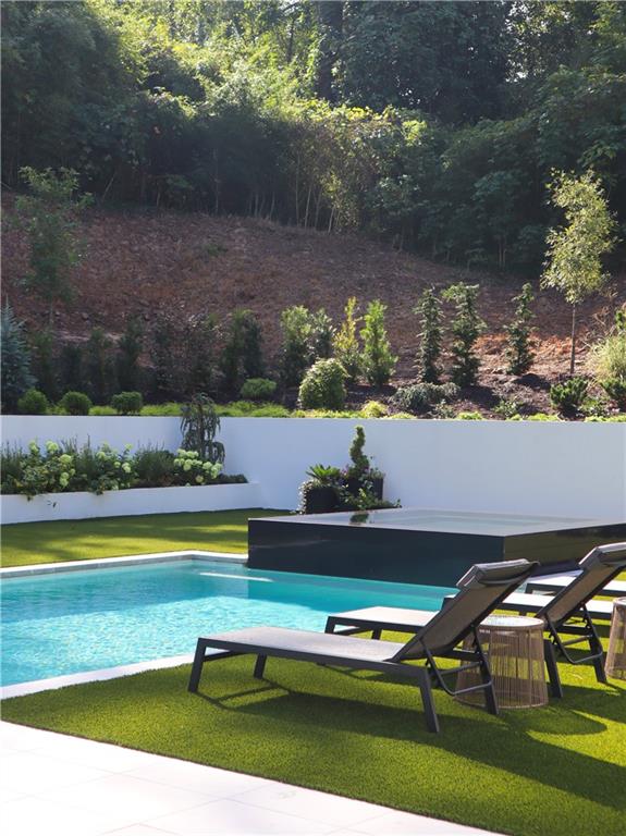380 West Wesley Road Northwest Atlanta, GA 30305 - Photo 76 of 104 a view of swimming pool with outdoor seating and yard