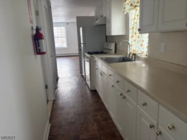 a kitchen with cabinets and window