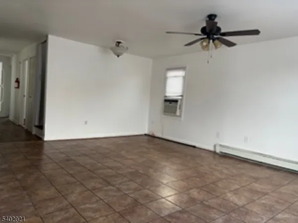 a view of a hallway with a chandelier fan