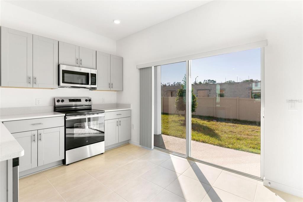 2987 Skyline Loop Kissimmee, FL 34758 - Photo 12 of 48 a kitchen with a stove a sink and a microwave