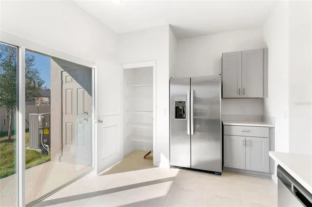 a kitchen with stainless steel appliances a refrigerator and a stove top oven