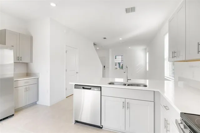 a view of a kitchen with kitchen island and a fireplace