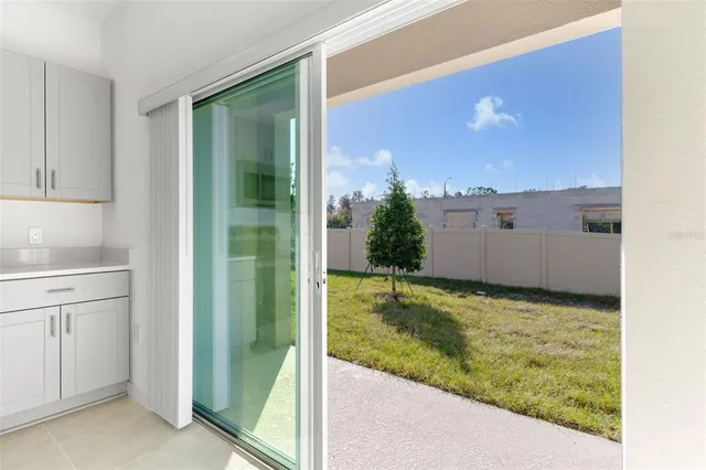 a view of a house with backyard and trees