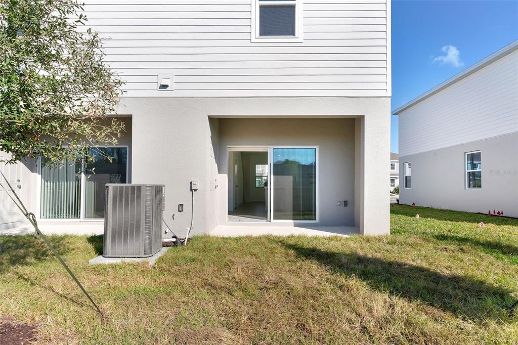 2987 Skyline Loop Kissimmee, FL 34758 - Photo 18 of 48 a view of a house with backyard and trees