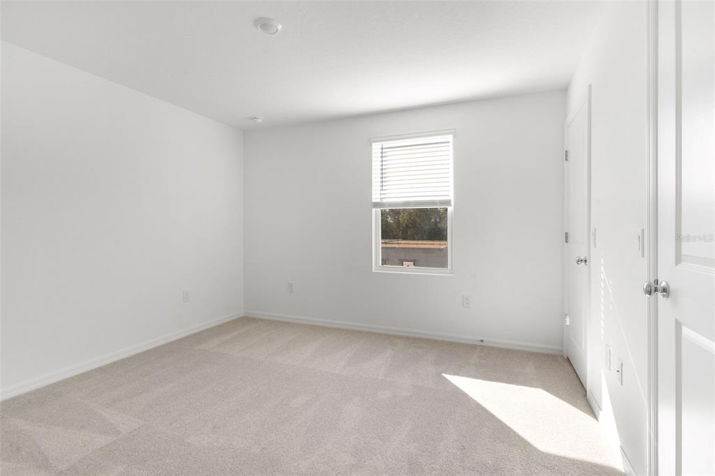 2987 Skyline Loop Kissimmee, FL 34758 - Photo 22 of 48 an empty room with a window