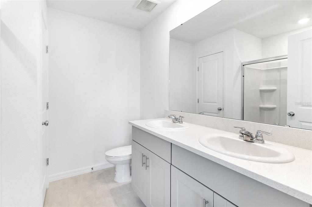 2987 Skyline Loop Kissimmee, FL 34758 - Photo 27 of 48 a bathroom with a sink toilet and a mirror